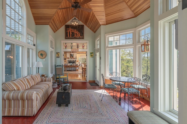 living area with plenty of natural light, wooden ceiling, wood finished floors, high vaulted ceiling, and baseboards