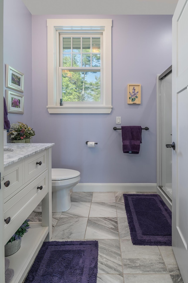 full bathroom with baseboards, vanity, a shower stall, toilet, and marble finish flooring