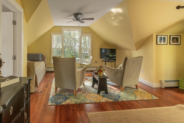 sitting room with a ceiling fan, hardwood / wood-style floors, a baseboard radiator, and vaulted ceiling