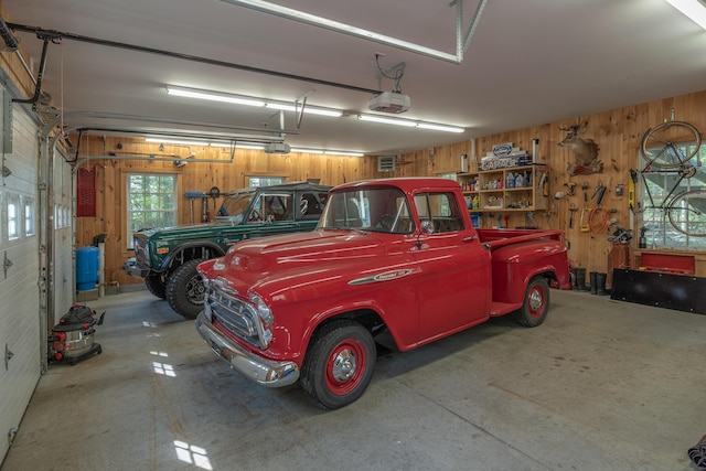 garage featuring wooden walls and a garage door opener