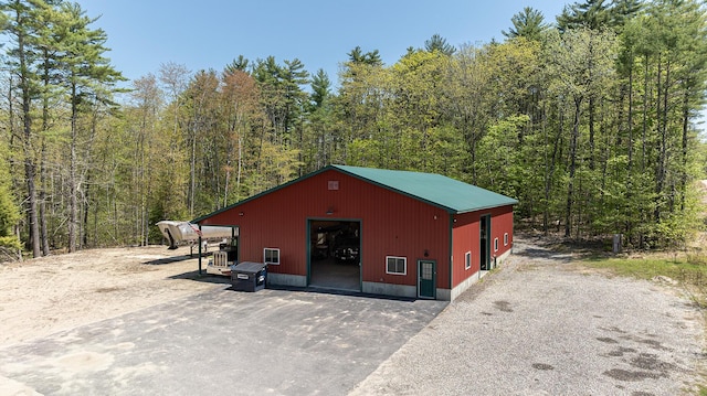 view of pole building with a wooded view