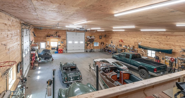 garage featuring a workshop area and wooden walls