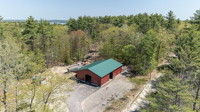aerial view of property and surrounding area featuring a forest