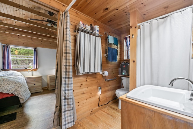 23 Woodland Rd, Winthrop, ME 04364 - full bathroom featuring wood finished floors, toilet, wood walls, wooden ceiling, and vanity
