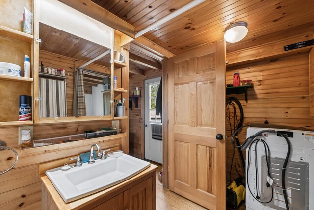 23 Woodland Rd, Winthrop, ME 04364 - bathroom featuring wood ceiling, wooden walls, wood finished floors, washer / dryer, and vanity