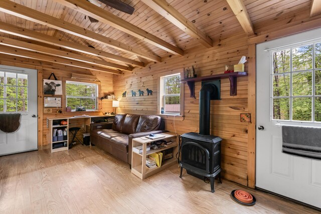 23 Woodland Rd, Winthrop, ME 04364 - living area featuring wood walls, plenty of natural light, wooden ceiling, a wood stove, and light wood-type flooring