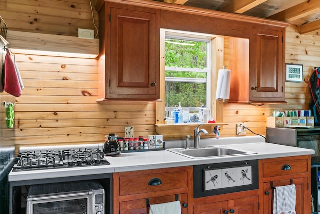 23 Woodland Rd, Winthrop, ME 04364 - kitchen with a sink, wood walls, light countertops, and brown cabinetry