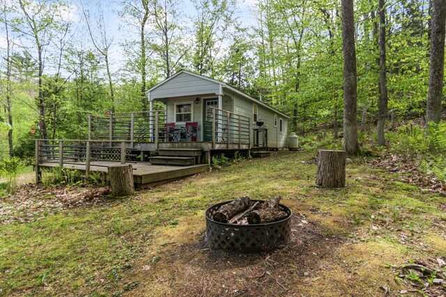 23 Woodland Rd, Winthrop, ME 04364 - view of front of house featuring an outdoor fire pit and a deck