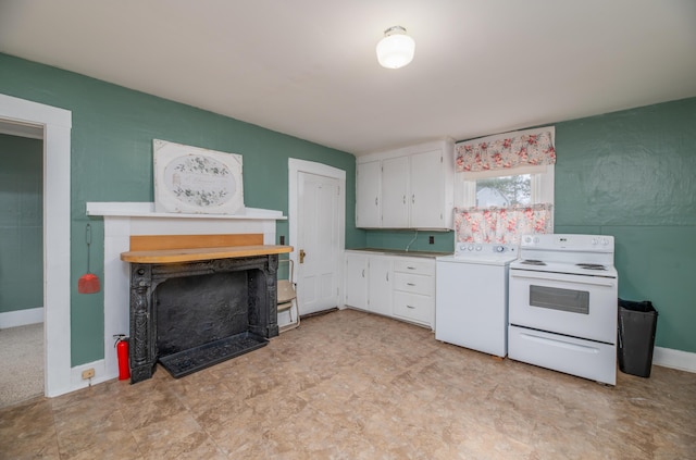 1 High St, Hallowell, ME 04347 - kitchen featuring washer / dryer, white range with electric cooktop, white cabinetry, light countertops, and a fireplace