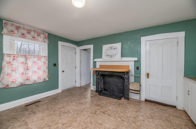 1 High St, Hallowell, ME 04347 - unfurnished living room with a fireplace and tile patterned floors