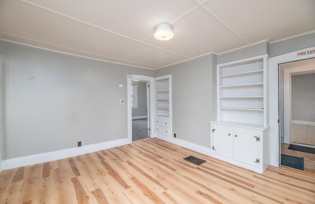 1 High St, Hallowell, ME 04347 - empty room with wood finished floors, baseboards, built in features, and crown molding