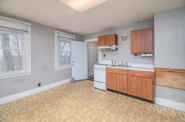 1 High St, Hallowell, ME 04347 - kitchen featuring white range oven, under cabinet range hood, a drop ceiling, light countertops, and a sink