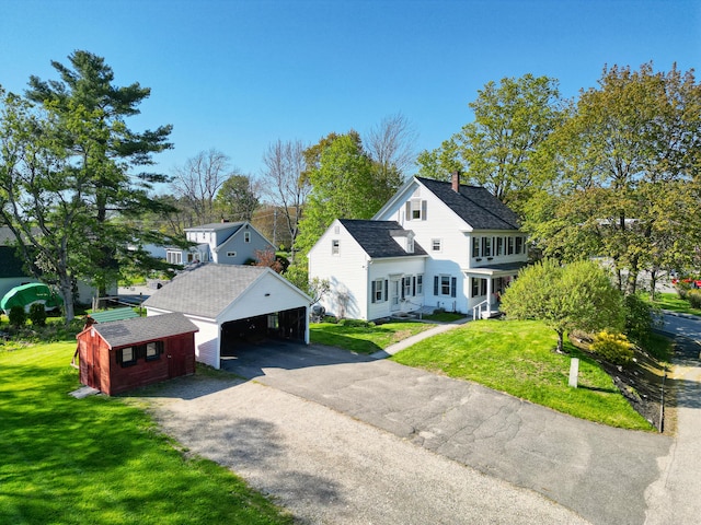 1 High St, Hallowell, ME 04347 - view of front facade with an outbuilding, driveway, a front yard, and a chimney