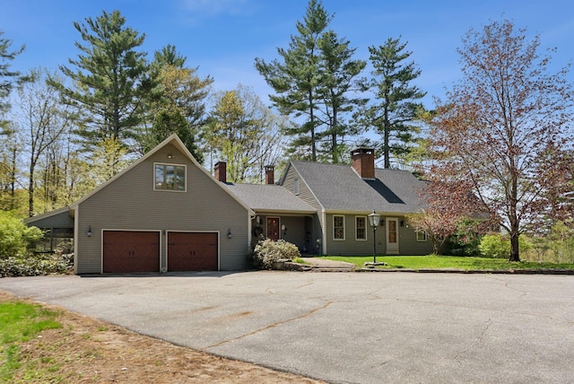 248 Morse Rd, Norway, ME 04268 - view of front facade featuring asphalt driveway, an attached garage, and a chimney