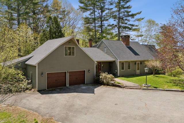 248 Morse Rd, Norway, ME 04268 - view of front of house featuring asphalt driveway, a chimney, a front yard, a garage, and a shingled roof
