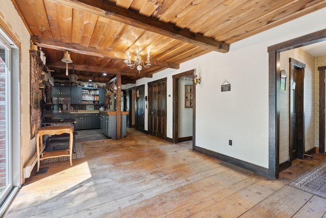 248 Morse Rd, Norway, ME 04268 - kitchen with light wood finished floors, stainless steel oven, a chandelier, beamed ceiling, and baseboards