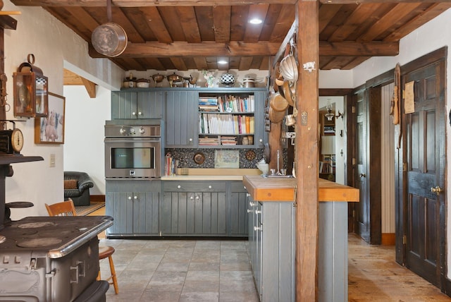 248 Morse Rd, Norway, ME 04268 - kitchen featuring stainless steel oven, wood ceiling, beamed ceiling, light countertops, and open shelves