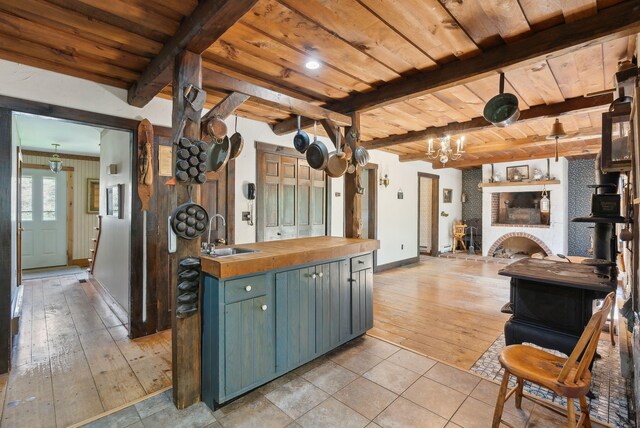 248 Morse Rd, Norway, ME 04268 - kitchen with wooden ceiling, wood counters, a sink, baseboards, and beamed ceiling