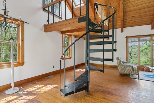 248 Morse Rd, Norway, ME 04268 - stairs featuring baseboards, wood finished floors, beam ceiling, plenty of natural light, and wood ceiling