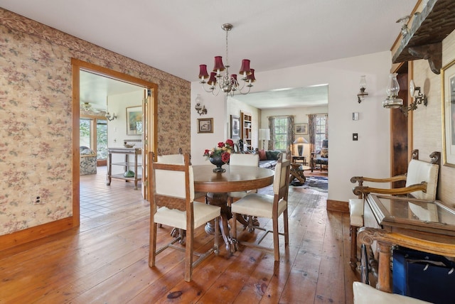 248 Morse Rd, Norway, ME 04268 - dining space with baseboards, light wood finished floors, wallpapered walls, and a chandelier