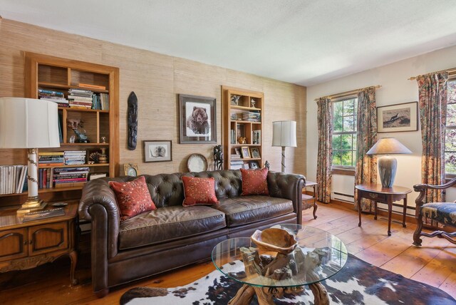 248 Morse Rd, Norway, ME 04268 - living area featuring wood-type flooring, built in shelves, and a baseboard heating unit