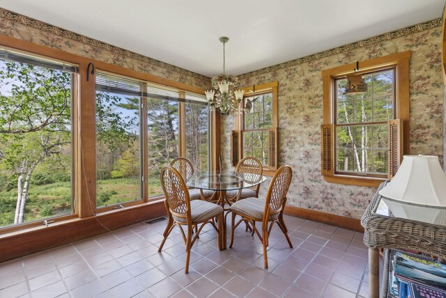 248 Morse Rd, Norway, ME 04268 - dining area with wallpapered walls, a chandelier, tile patterned floors, and baseboards