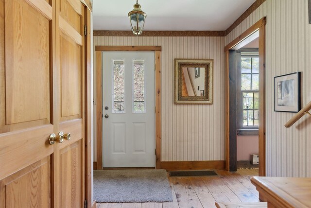 248 Morse Rd, Norway, ME 04268 - entryway with wallpapered walls, light wood-style flooring, and baseboards