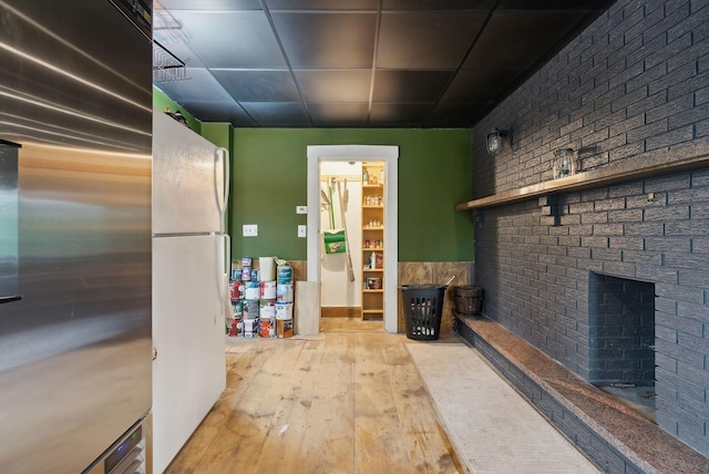 692 S St, Biddeford, ME 04005 - interior space featuring hardwood / wood-style flooring, brick wall, and a fireplace
