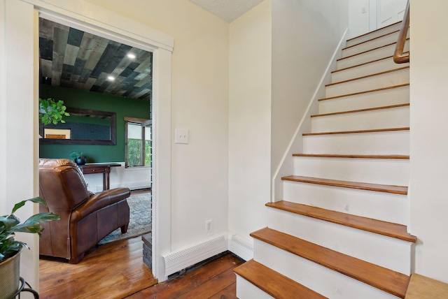692 S St, Biddeford, ME 04005 - stairs featuring hardwood / wood-style flooring, a baseboard heating unit, and baseboards