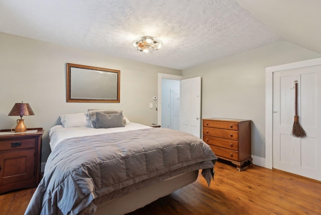 692 S St, Biddeford, ME 04005 - bedroom featuring light wood-style floors, a textured ceiling, and baseboards