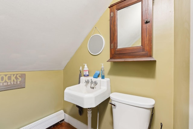692 S St, Biddeford, ME 04005 - half bathroom with a baseboard radiator, lofted ceiling, toilet, and baseboards