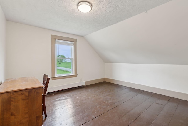 692 S St, Biddeford, ME 04005 - additional living space featuring hardwood / wood-style floors, lofted ceiling, a baseboard radiator, a textured ceiling, and baseboards