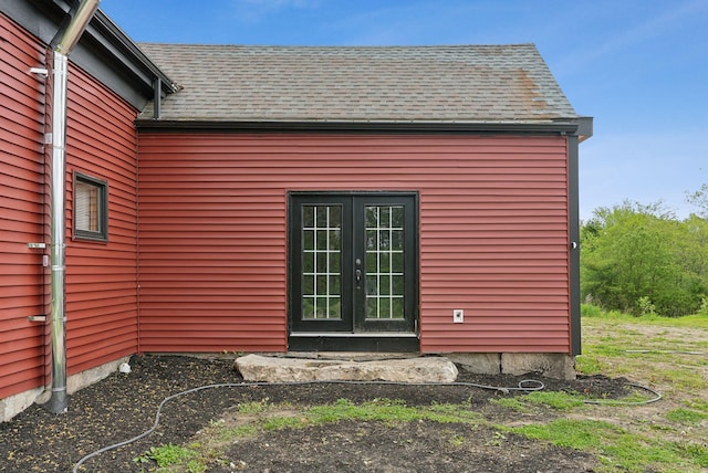 692 S St, Biddeford, ME 04005 - view of home's exterior with french doors and a shingled roof