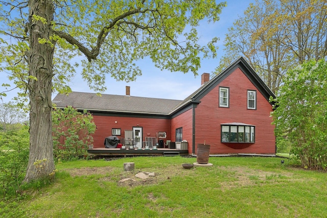 692 S St, Biddeford, ME 04005 - rear view of house featuring a wooden deck, a chimney, and a lawn