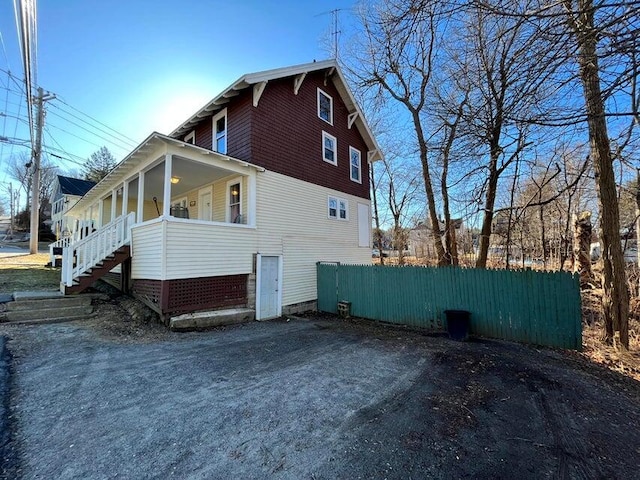 30 Patterson St, Augusta, ME 04330 - view of home's exterior featuring a porch, stairway, and fence