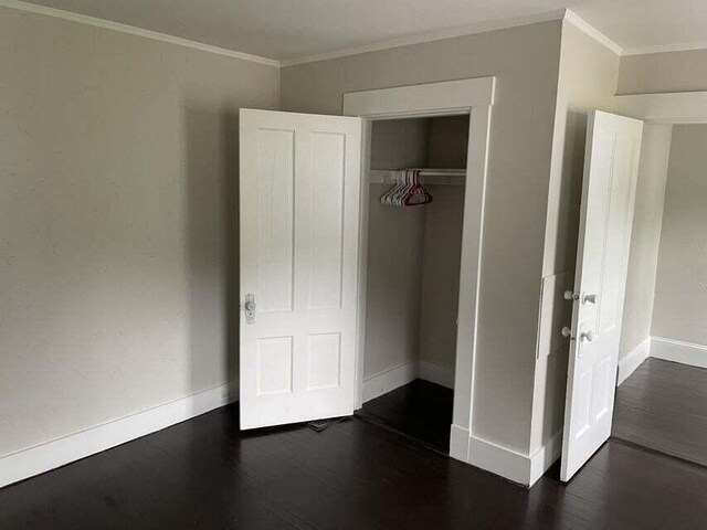 30 Patterson St, Augusta, ME 04330 - unfurnished bedroom featuring baseboards, wood finished floors, crown molding, and a closet