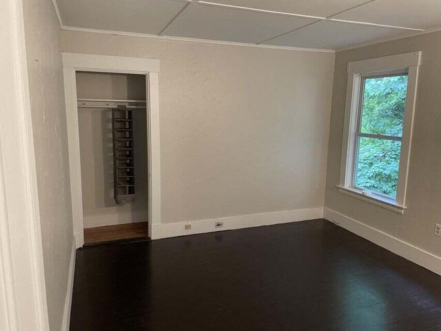 30 Patterson St, Augusta, ME 04330 - unfurnished bedroom with ornamental molding, baseboards, dark wood-type flooring, and a closet