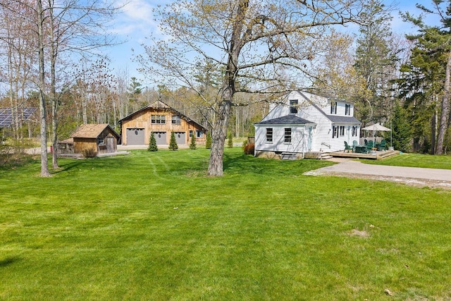 45AND57 Southgate Rd, Kennebunk, ME 04043 - view of green lawn with an outbuilding, a detached garage, a deck, and a storage unit