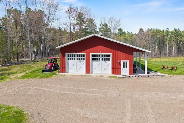 45AND57 Southgate Rd, Kennebunk, ME 04043 - detached garage featuring a wooded view and driveway