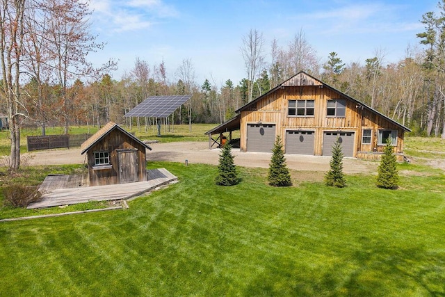 45AND57 Southgate Rd, Kennebunk, ME 04043 - view of green lawn with a garage, driveway, and a forest view