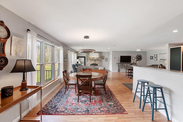 45AND57 Southgate Rd, Kennebunk, ME 04043 - dining room with light wood-style floors, recessed lighting, a fireplace, and baseboards