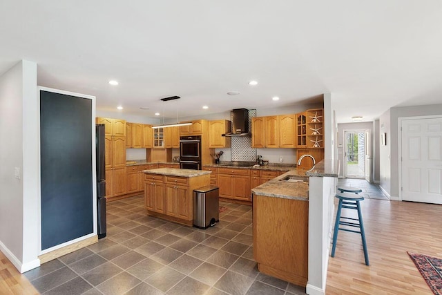 45AND57 Southgate Rd, Kennebunk, ME 04043 - kitchen with wall chimney exhaust hood, black appliances, a sink, baseboards, and recessed lighting