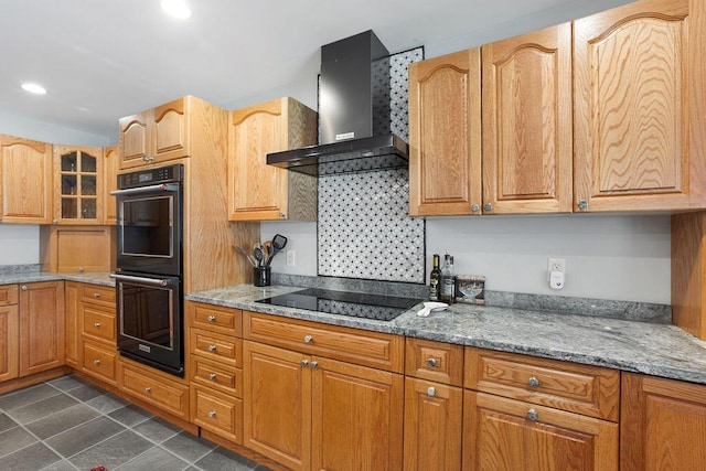 45AND57 Southgate Rd, Kennebunk, ME 04043 - kitchen featuring wall chimney range hood, black appliances, light stone countertops, glass insert cabinets, and recessed lighting