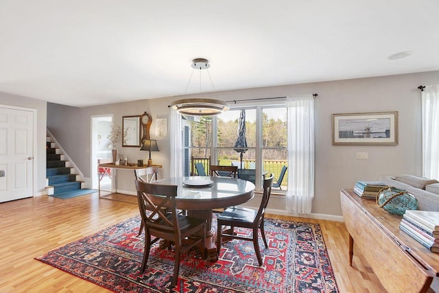 45AND57 Southgate Rd, Kennebunk, ME 04043 - dining room with wood finished floors, stairway, and baseboards