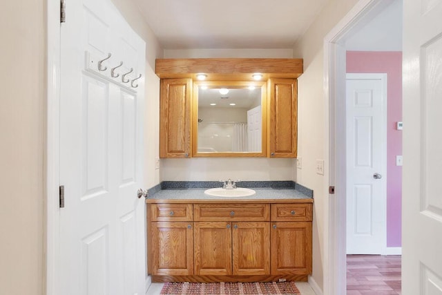 45AND57 Southgate Rd, Kennebunk, ME 04043 - full bath with vanity, curtained shower, and wood finished floors