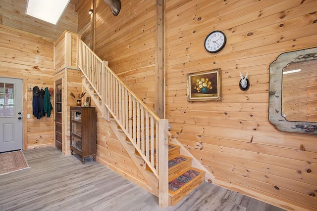 45AND57 Southgate Rd, Kennebunk, ME 04043 - stairway with wood walls, wood finished floors, and high vaulted ceiling