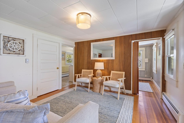 19 Fairhaven Ave, Saco, ME 04072 - living room featuring a baseboard radiator, plenty of natural light, wood finished floors, crown molding, and wood walls