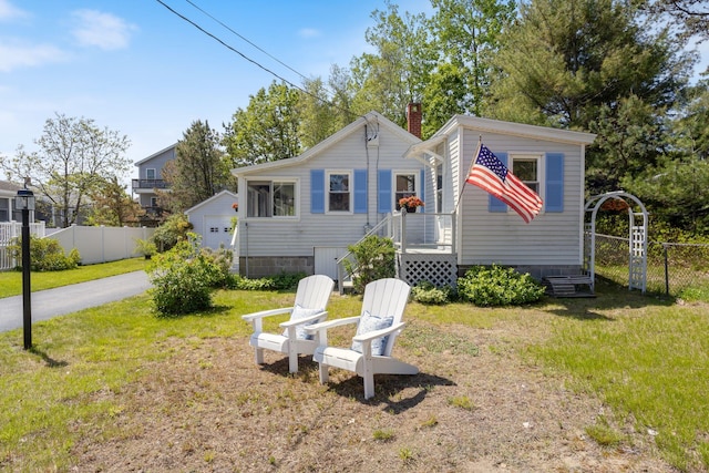 19 Fairhaven Ave, Saco, ME 04072 - view of front facade featuring a garage, an outbuilding, and a chimney