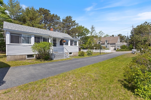 19 Fairhaven Ave, Saco, ME 04072 - view of front facade featuring a front lawn, roof with shingles, and a chimney