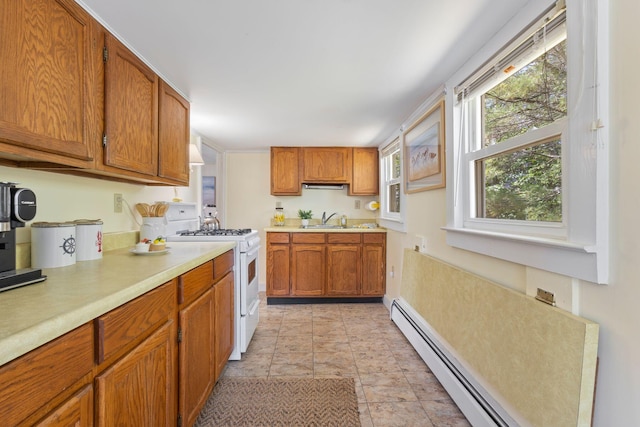 19 Fairhaven Ave, Saco, ME 04072 - kitchen with white gas stove, a sink, light countertops, and brown cabinets